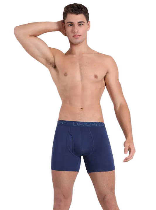 Man wearing navy blue boxer briefs with 'DAVID' branding on a white background