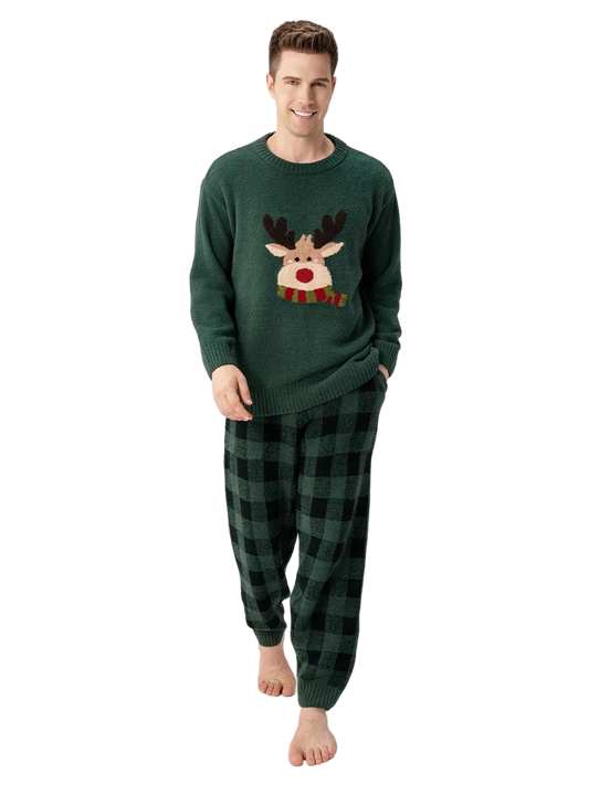 Man wearing a green Christmas-themed sweater and plaid pants on a white background